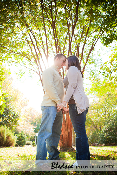 "Amy and Scott in front of a sunlit tree at UT Gardens"