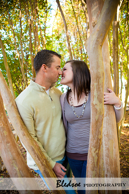 "Amy and Scott laugh under the trees at UT Gardens"