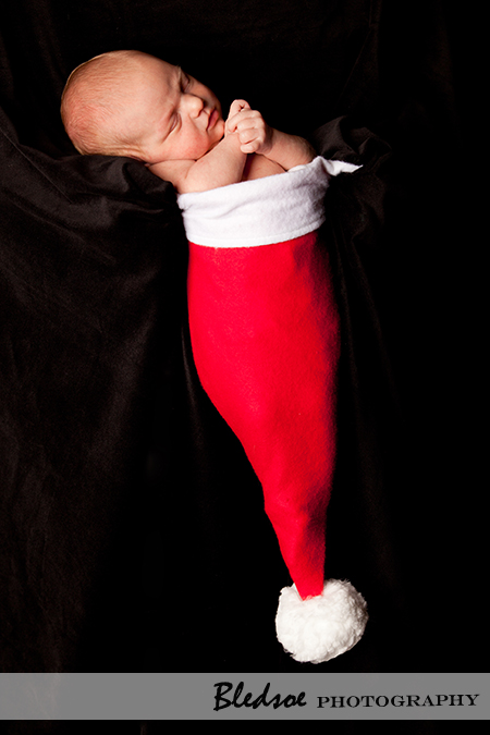 "Newborn Baby in a Santa Hat"
